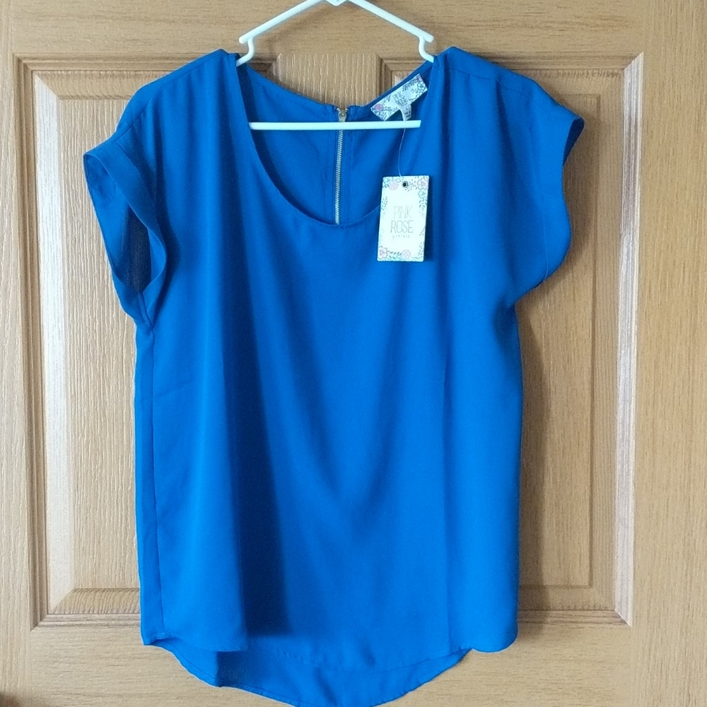 Blue flowy shirt with gold detail.